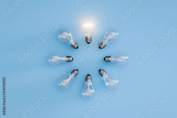Fototapeta Illuminated Bulb In Circle of Unlit Light Bulbs