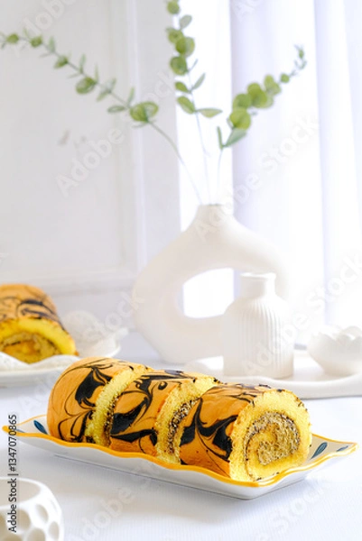 Fototapeta slice roll cake in plate