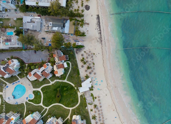 Obraz A beach with a resort and a pool