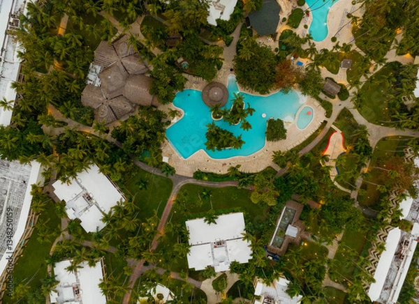 Obraz A beautiful tropical resort with a pool and palm trees