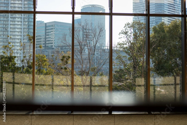 Fototapeta City View Through Large Window with Greenery