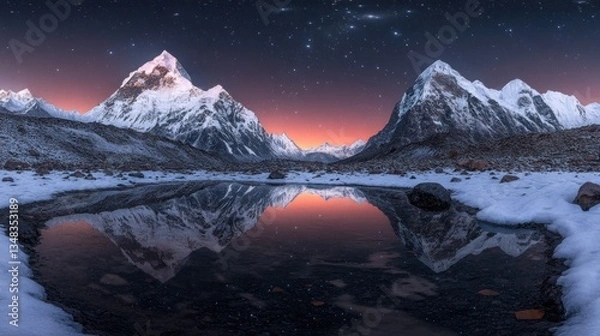 Fototapeta Majestic snow-capped mountains reflecting in a tranquil winter lake at dawn