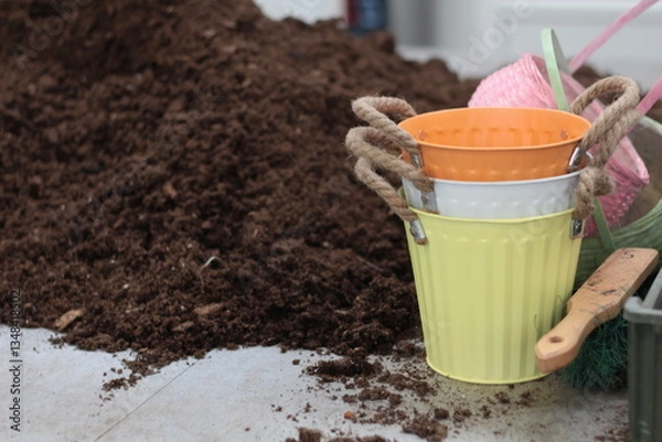 Fototapeta Spring gardening scene in a greenhouse with pots, rich black soil, and fresh seedlings ready for planting. The perfect image to illustrate gardening blogs, horticulture articles, and spring planting