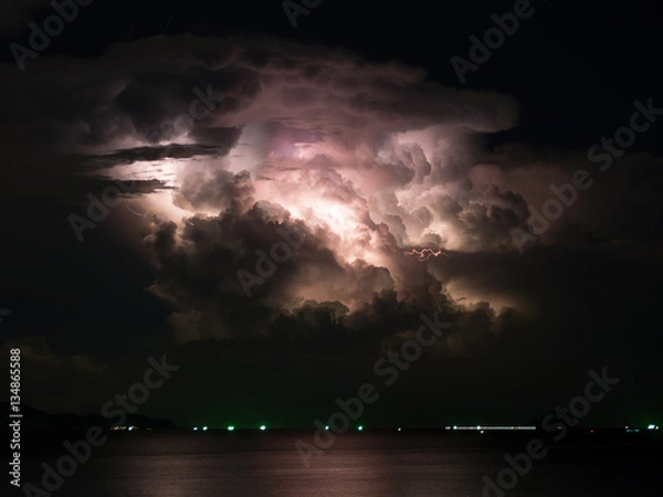 Obraz Mostly cloudy, with a lightning storm inside.