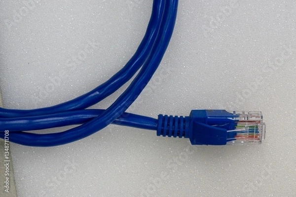 Fototapeta Ethernet patch cable rolled up on white