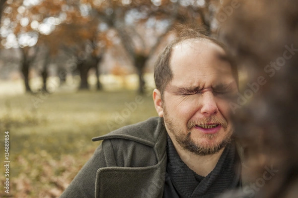 Fototapeta Man having make up by a stylist. Outdoors