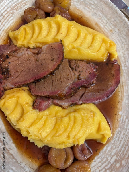 Obraz Restaurant food, pork roast with mashed pumpkin, chestnuts and gravy. Autumn food in mountain area.