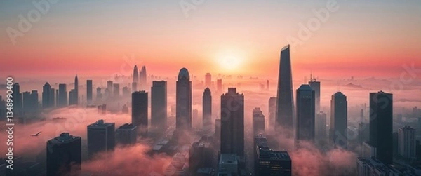 Fototapeta The city skyline awakens as the sun rises, casting a warm glow over towering buildings enveloped in soft fog. A serene and beautiful start to the day, showcasing urban beauty