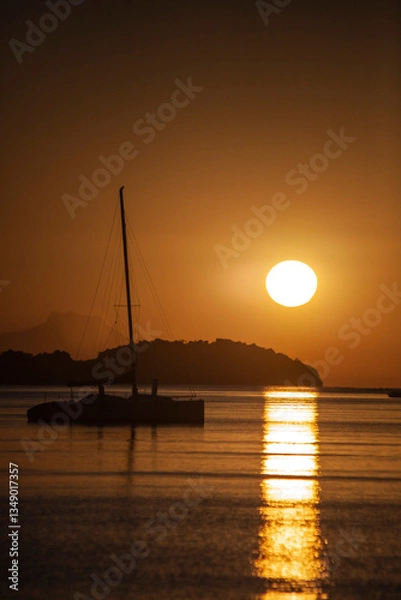 Obraz Silhouette of a sailboat with sunrise in the background off the coast of Brazil