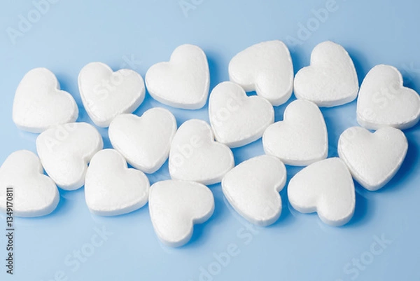 Obraz The medical concept of diseases of the human cardiovascular system. A heart-shaped tablet on a blue background. Selective focus..