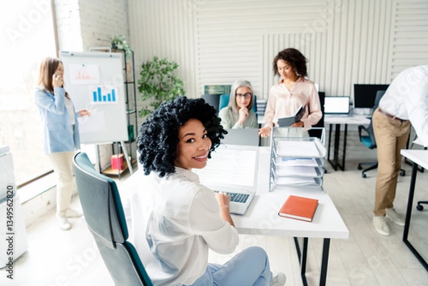 Fototapeta Diverse team working together in modern office space with collaborative atmosphere