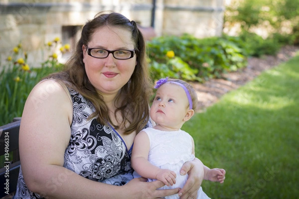 Obraz Happy mother and daughter together in the park on summer day