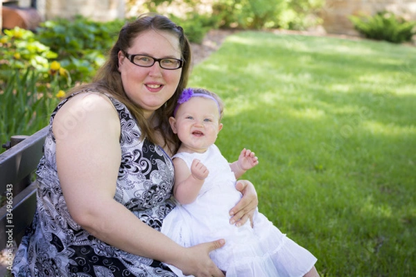 Obraz Happy mother and daughter together in the park on summer day