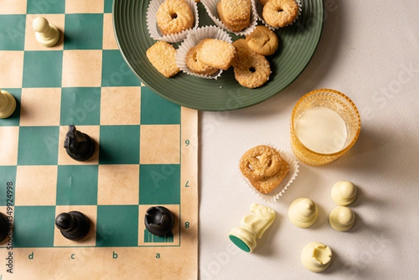 Obraz Enjoying chess and cookies with milk on a relaxing evening