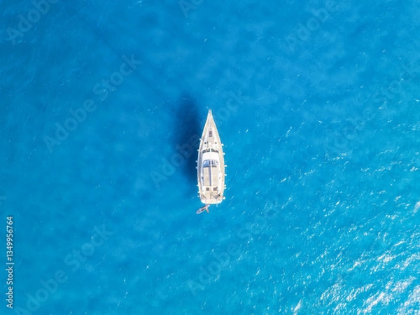 Fototapeta Summertime vacation. Drone view on the yacht. Sail yacht on the sea as a background. .Transparent sea water and waves. Photography for background, postcards, wallpapers.
