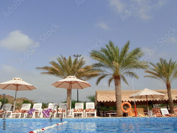Fototapeta pool side, palm trees, umbrellas, pool, sun bathe