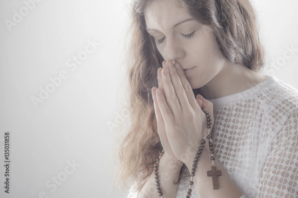 Obraz Praying woman on white background with shine.