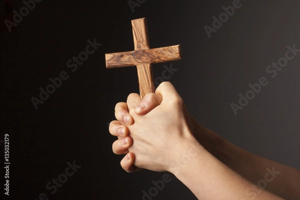 Obraz Hands with cross on dark background