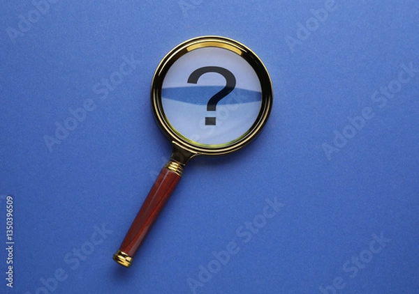 Fototapeta Question mark on blue background, top view through magnifying glass