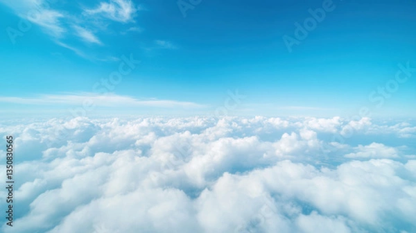 Fototapeta Fluffy white clouds blanket sky, creating serene and dreamy atmosphere against bright blue backdrop