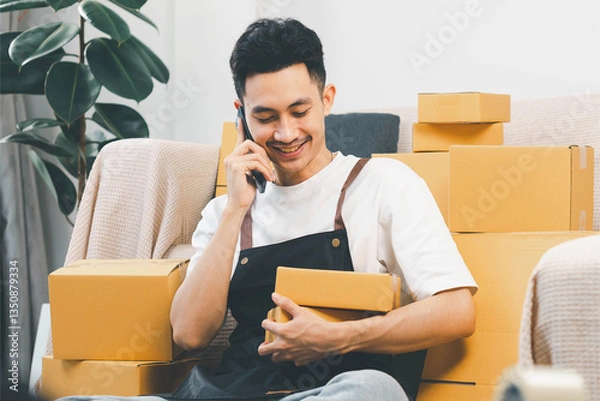 Fototapeta Startup small business, man working freelance and packing box delivery products to customers, Ordered online. packing boxes for online orders ready for shipping, Pack products box delivery products.