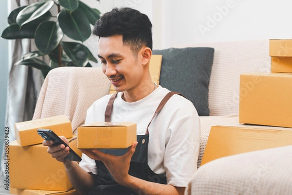 Obraz Startup small business, man working freelance and packing box delivery products to customers, Ordered online. packing boxes for online orders ready for shipping, Pack products box delivery products.