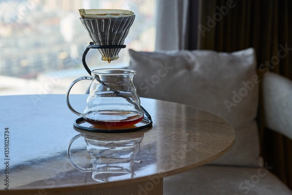 Fototapeta filtered coffeepot on table beside cozy sofa