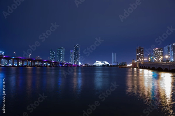 Fototapeta View on Miami Downtown and MacArthur Causeway at night time with a view on a bay, Sunset. USA