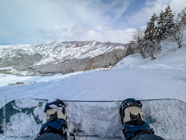 Fototapeta Snowboarder POV Atop Snowy Slope