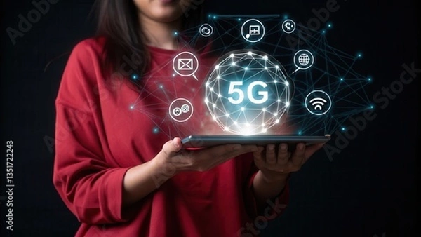 Obraz 5G network. Woman in red sweater holds tablet displaying a glowing 5G sphere with digital icons, against a dark background. The image emphasizes