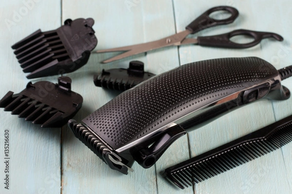 Obraz hair trimmer with comb and scissors on the wooden background
