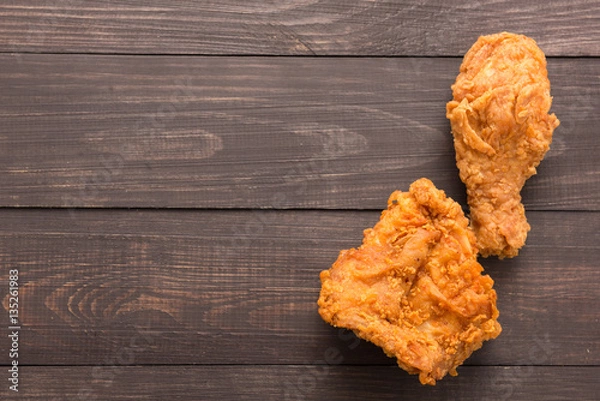 Obraz Fried chicken drumstick and chicken breast on the wooden backgro