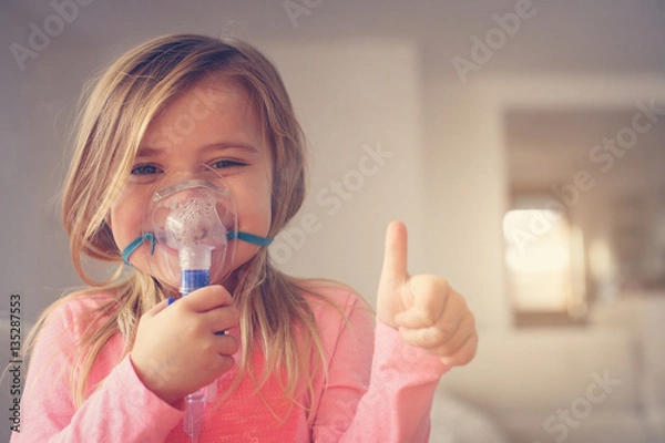 Obraz Little girl using inhaler.