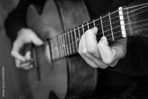 Fototapeta Man playing classical guitar. Black and white photo.