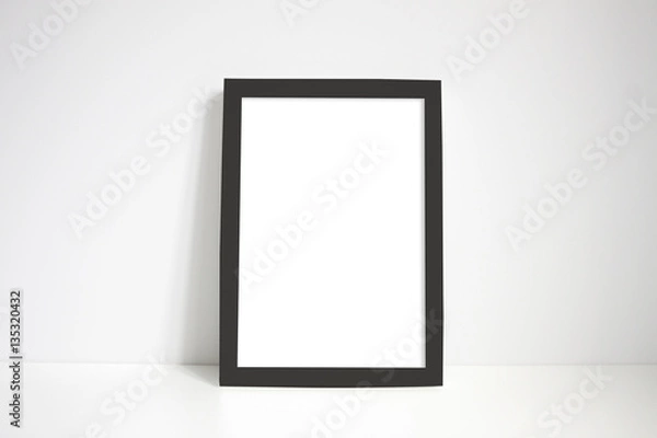 Obraz Black portrait frame against white wall