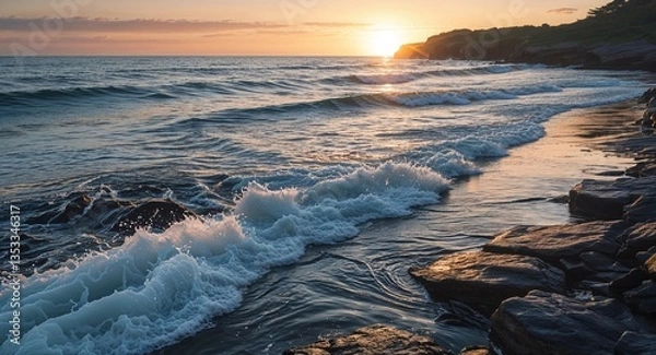 Obraz Ocean waves gently lapping against rocky shoreline during sunrise