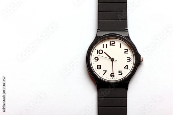 Fototapeta Classic uni-sexual black and white wrist watch on the white background, close up.