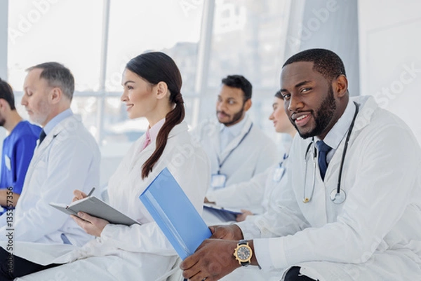 Fototapeta Professional general practitioners having conversation at clinic