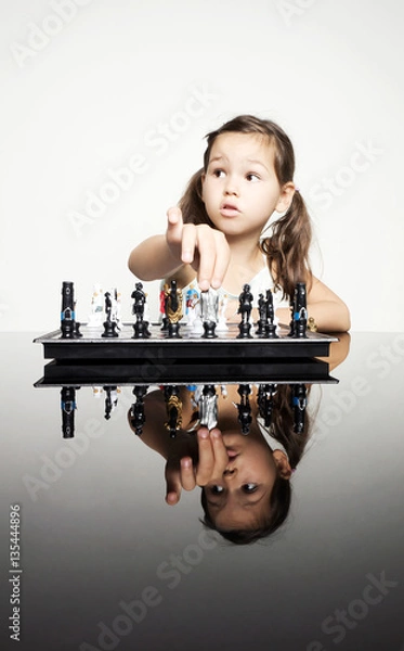 Fototapeta Adorable little girl playing real chess in competition