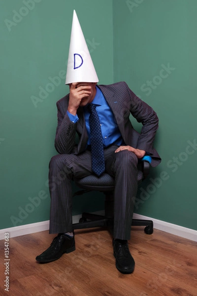 Obraz Businessman wearing a dunce hat