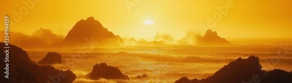 Fototapeta Golden sunlight illuminates mountains on the rough ocean horizon at sunset