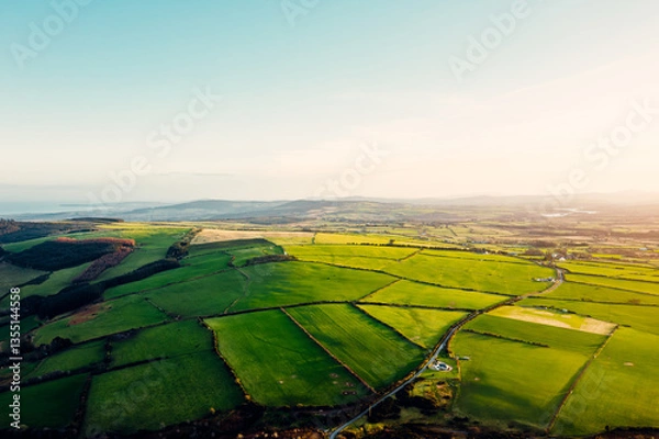 Obraz Aerial View of Scenic Green Fields and Countryside Road in Wicklow, Ireland at Sunset