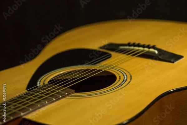 Fototapeta Acoustic guitar on black background