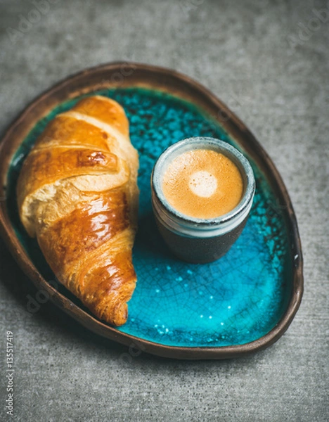 Obraz Cup of espresso coffee and croissant in turquoise blue ceramic tray over grey concrete background, selective focus