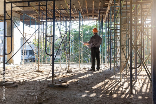 Fototapeta Construction concepts, Engineer and Architect working at Construction Site with blueprint