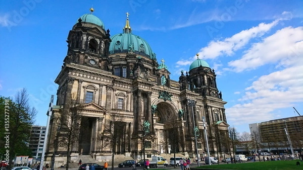 Fototapeta The impressive Berlin Cathedral with its striking domes surrounded by lush trees