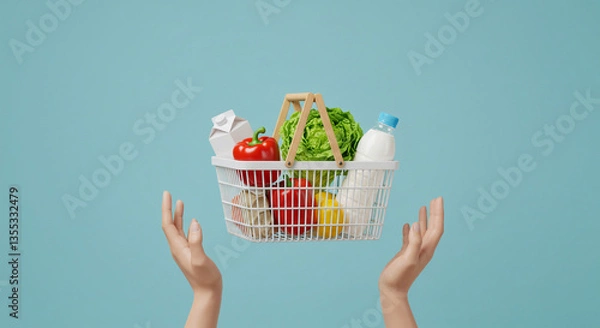 Fototapeta A conceptual and minimalist stock image depicting a modern shopping basket suspended above a pair of outstretched hands, symbolizing online shopping, grocery delivery