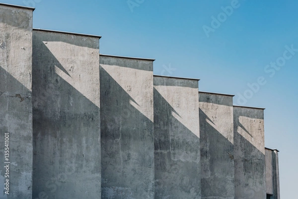 Fototapeta Staggered Concrete Facade with Dramatic Angular Shadows