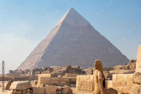 Fototapeta Back view of woman looking at Great Pyramids of Chephren and Cheops, Cairo, Egypt. Two of the three Great Pyramids, Giza pyramid complex (Giza Necropolis)