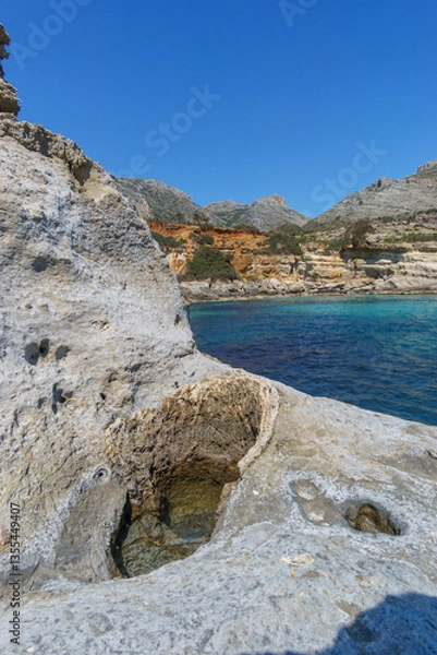 Fototapeta Hole of petrified tree trunk at Geopark of Agios Nikolaos a Petrified Forest at mediterranean sea coast, Laconia, Peloponnese, Greece